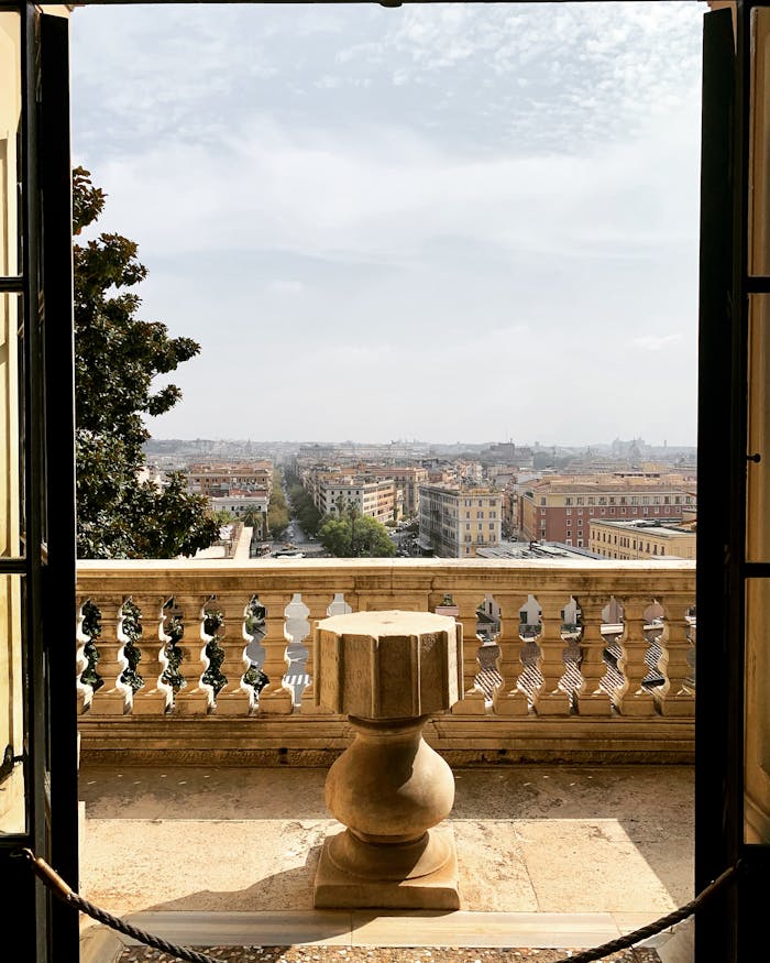 pexels photo 9955007 Breathtaking panorama of Rome cityscape from a classic Italian balcony.